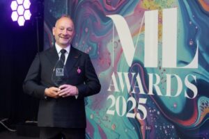 Nick Johnson holding lifetime achievement award at 2025 ML Awards